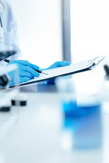 Technician recording quality test results in the laboratory
