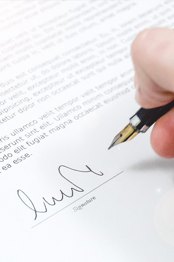 ISO 22716 cosmetics manufacturing certification document being signed