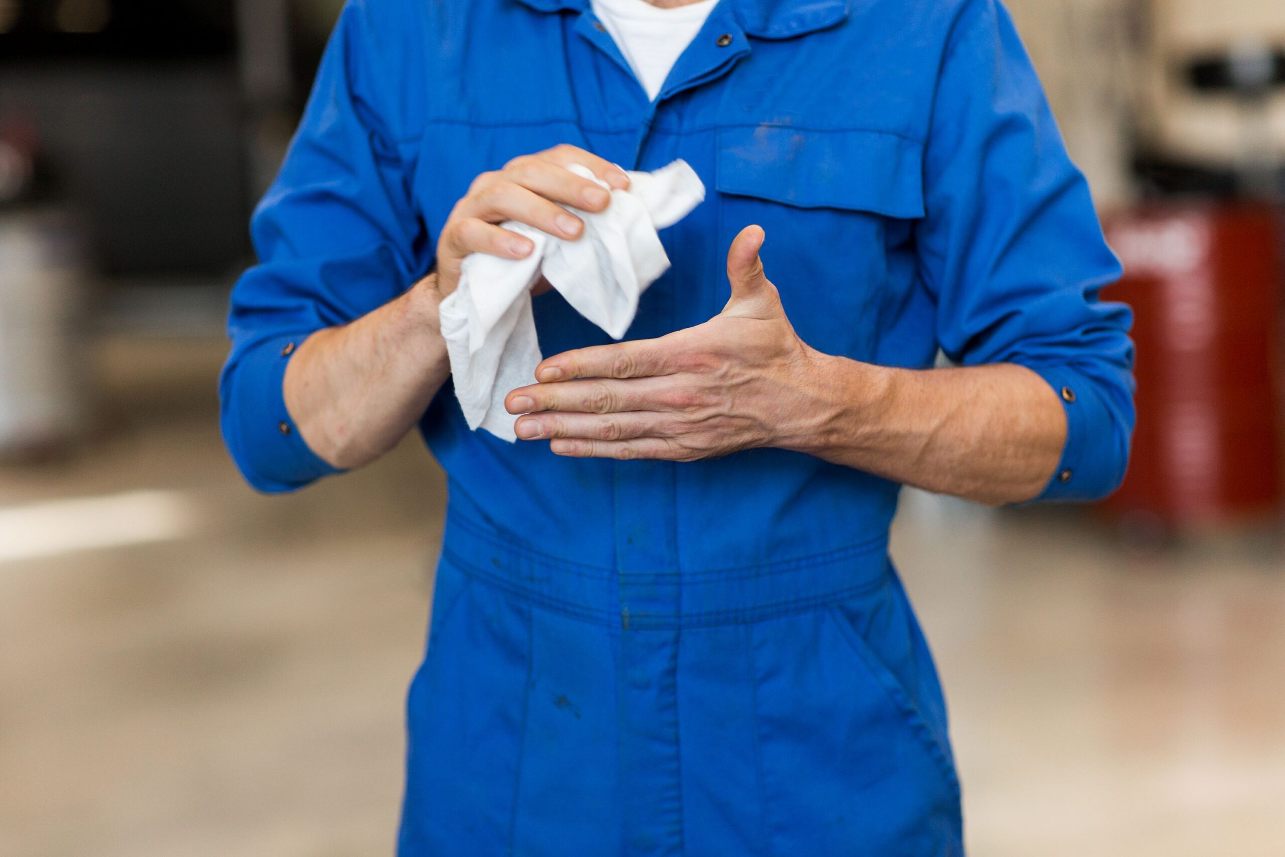 Industrial cleaning wipe removing grease from hands in a workshop