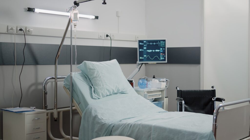 Bilik pesakit hospital dengan katil, tiang IV dan monitor, iaitu tempat yang menggunakan bahan guna habis perubatan setiap hari