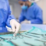 Surgical team in blue disposable gowns with instruments laid on a nonwoven tray wrap, typical uses of SMS fabric