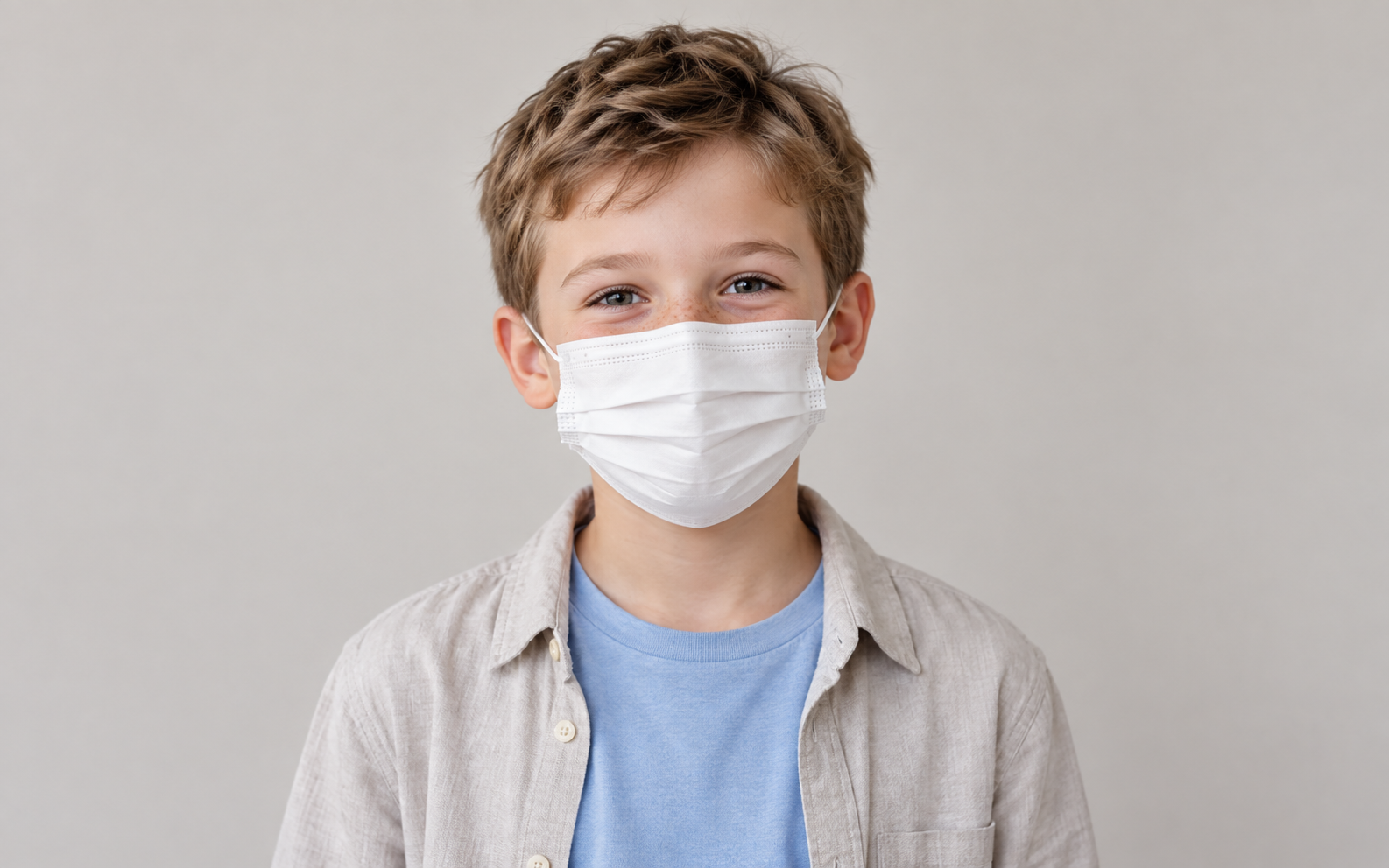 Child wearing a white disposable face mask