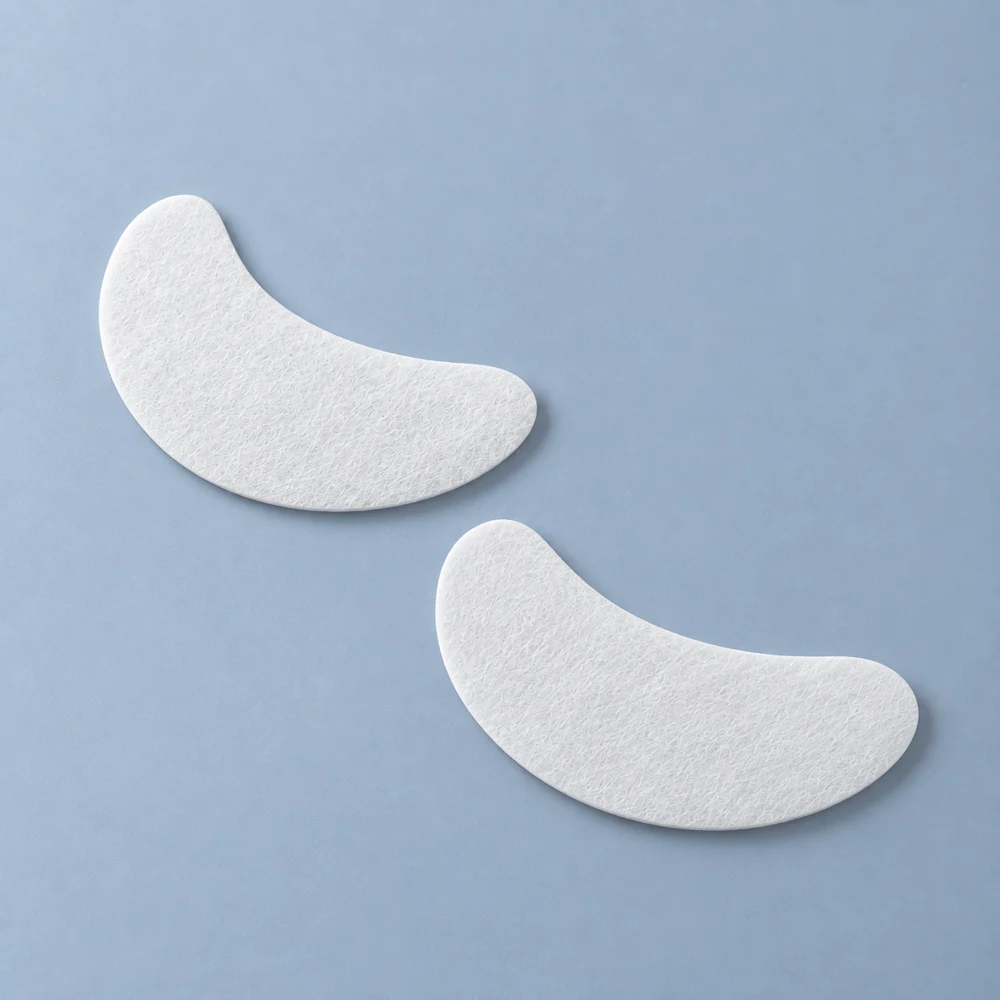 Two crescent-shaped white nonwoven eye mask sheets