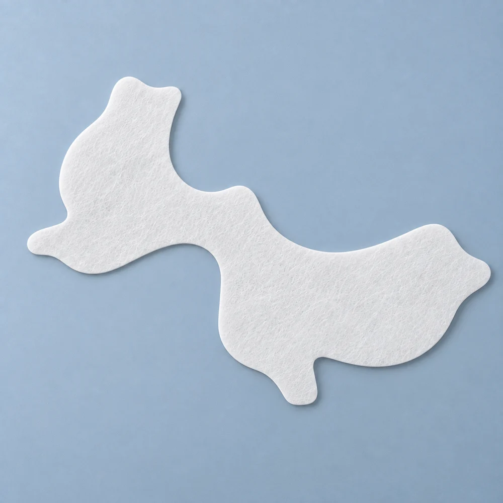 White nonwoven cheek mask sheet cut to follow the contours of the face