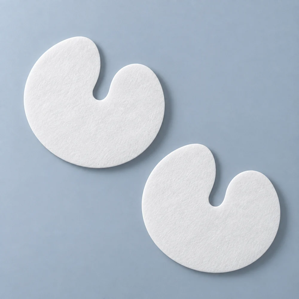 Two C-shaped white nonwoven breast mask sheets