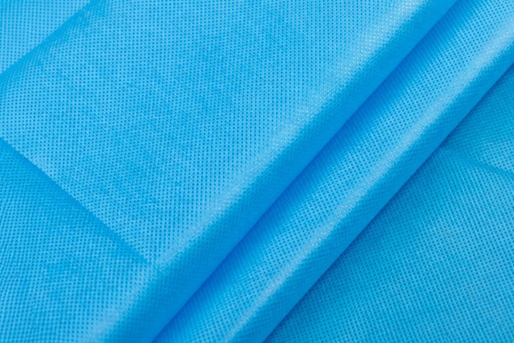 ผ้าสปันบอนด์สีน้ำเงินที่มีลายจุดจากการยึดเส้นใย